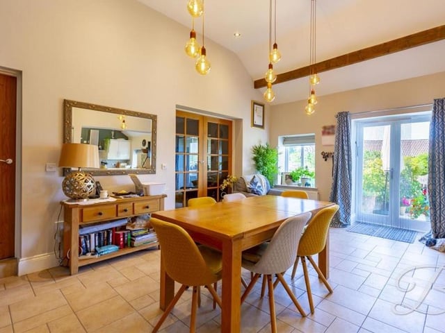 The dining room, which gives a great sense of space, is a beautiful spot for family meals. The patio doors lead outside into the garden.