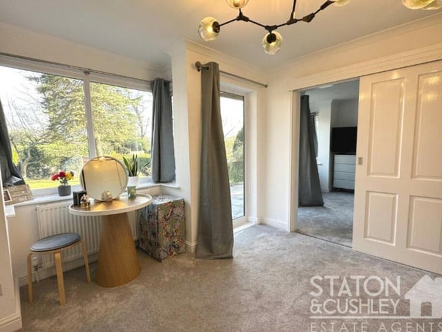 This walk-in dressing room is attached to the master bedroom. It features a door opening out on to the back garden