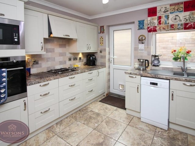 Other integrated appliances in the kitchen include a waist-height electric oven, and also a microwave. There is an inset one-and-a-half bowl sink and drainer unit.