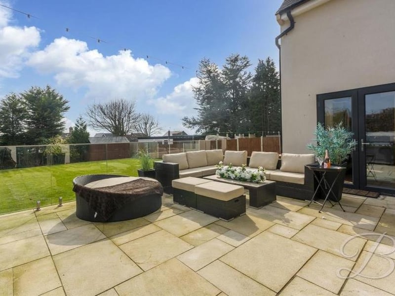 This raised patio, with glass balustrade, provides the perfect spot for relaxing or for entertaining family and friends.