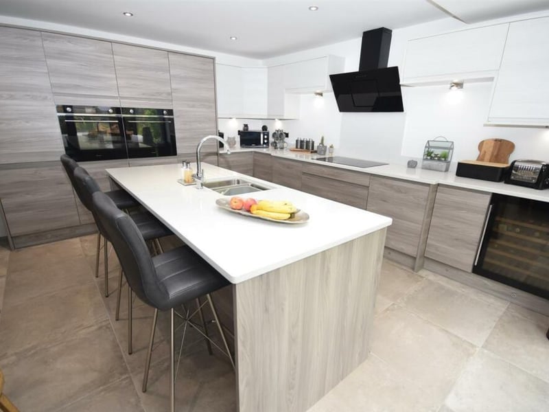 A last look at the open-plan kitchen, which also benefits from underfloor heating, a wine cooler and atmospheric downlighting.