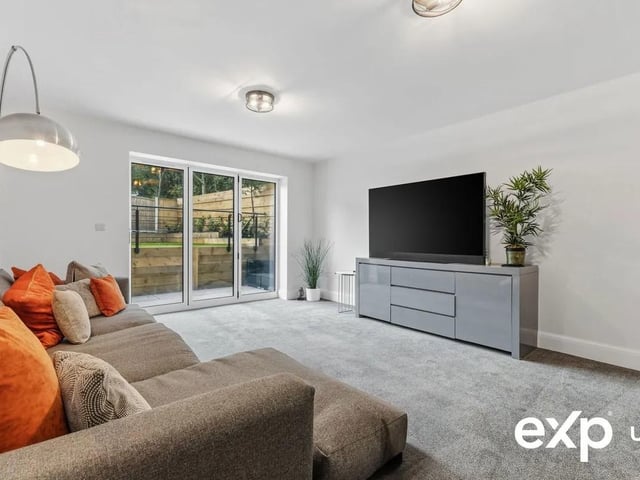 The spacious lounge featuring bi-folding doors along with a uPVC window to the rear.