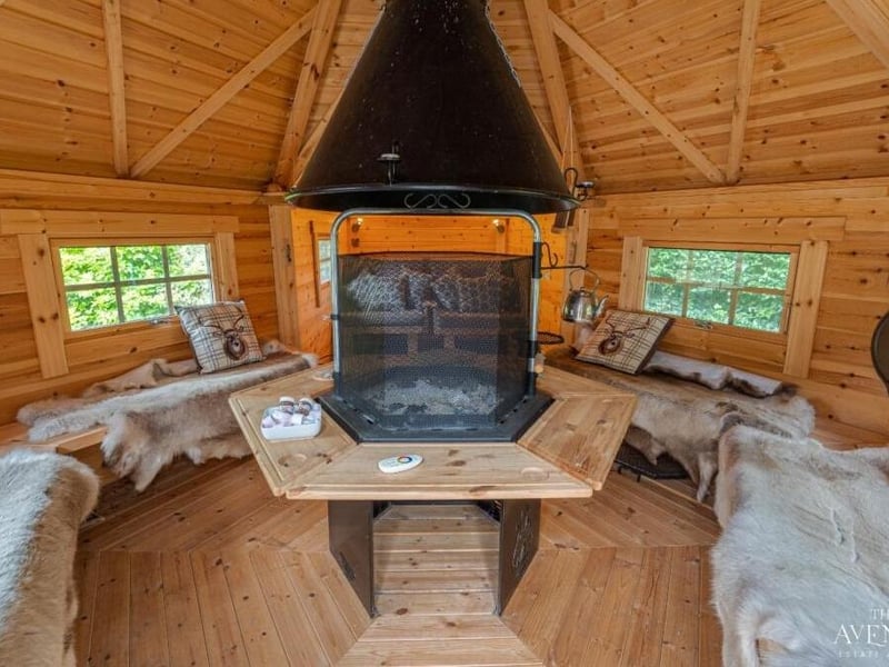 A peek inside the wooden chalet-style kota reveals a heater for cooking or heating food and two single futons, ideal for fun sleepovers.