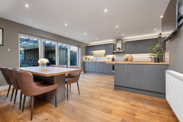 As eyecatching as the lounge is this spectacular, open-plan living kitchen, complete with dining area. Yet more bi-folding doors open out on to the rear garden.