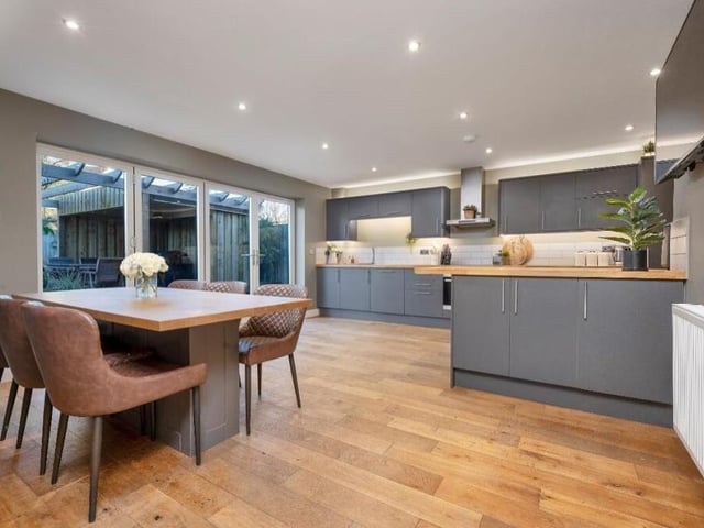 As eyecatching as the lounge is this spectacular, open-plan living kitchen, complete with dining area. Yet more bi-folding doors open out on to the rear garden.