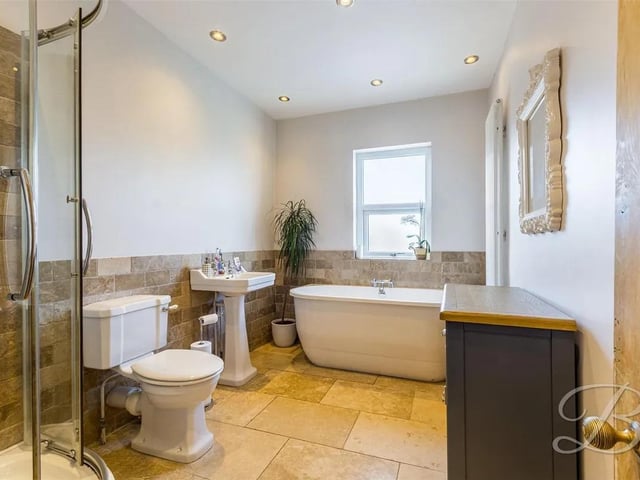 Stylish four piece suite comprising of a hand wash basin, low flush WC, shower and a free standing bath. Window to the rear elevation.