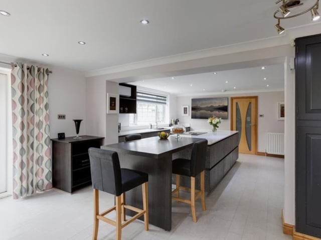 We start our tour of The Hollies in the room estate agents Blenheim Park Estates make such a fussy of, and rightly so. It's the bespoke and spacious Karl Benz breakfast kitchen, which includes a central island with a matching quartz work surface and four-ring Bora induction hob. The work surface extends to provide three breakfast chairs.