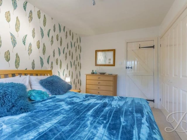 More extensive, built-in wardrobe space can be found in this colourful bedroom.