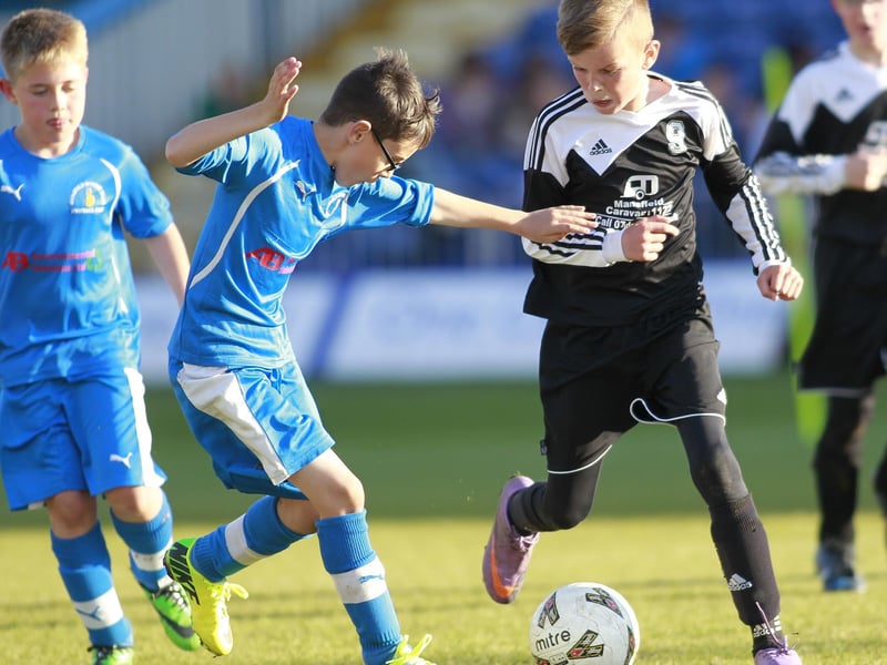 Welbeck's Ethan Mellors is kept in check by Hosiery Mills' Joshua Fowler.
