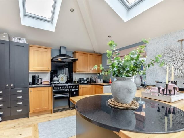 Appliances within the kitchen that are integrated or are part of the sale include three electric ovens, a five-ring gas hob and fitted extractor hood, a free-standing range cooker, a wine cooler, dishwasher and fridge.