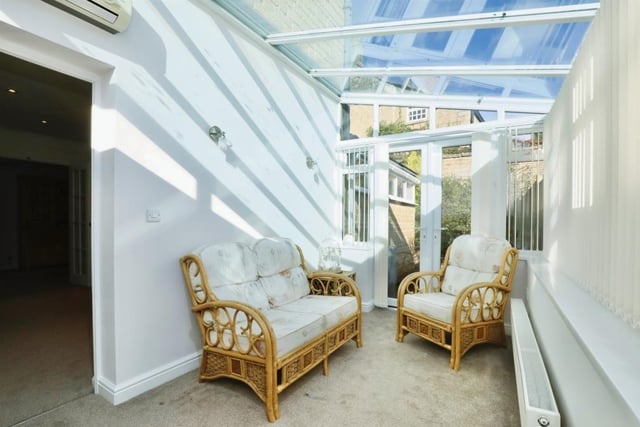 This versatile sun room can be used as a snug or a sitting room, with air-conditioning making it a comfortable space. French doors lead to the back garden.