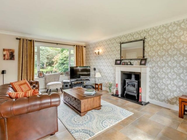 The living room features a superb limestone fireplace with an inset log-burner-style gas fire and granite hearth.