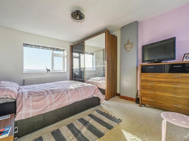 Here is the first of the bedrooms on the first floor. A generous size, it boasts large wardrobes, a carpeted floor and windows to the front and back of the house.