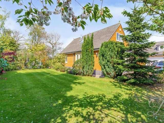 The garden, with its lovely lawn and mature trees, is superbly maintained.