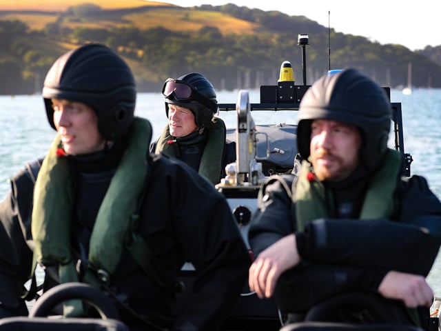 The crew of HMS Tamar taking part in exercises at sea.