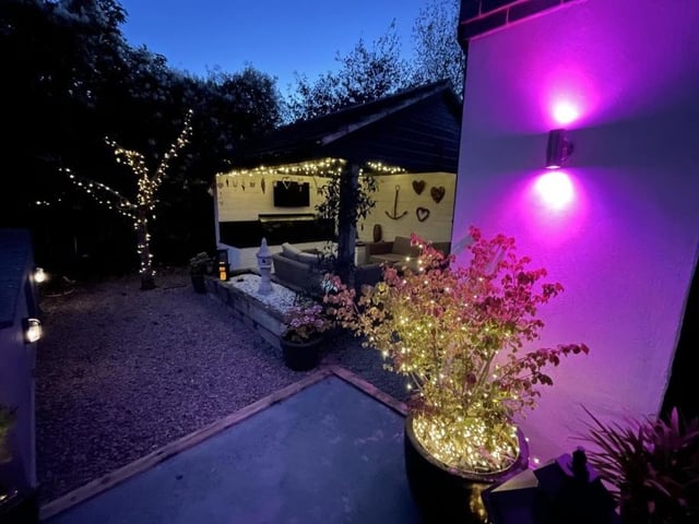 Strategically placed lights make the rear garden an appealing place to spend the night with friends in summer.