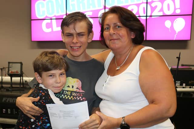 Marshall Fairbrother celebrates his grade 4 in maths with his mum and brother