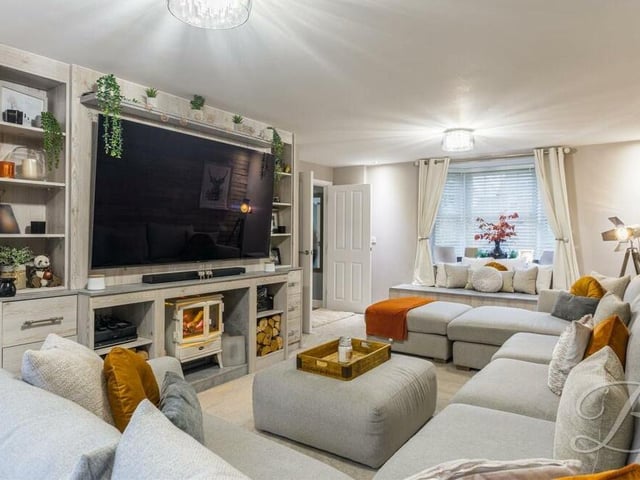 The living room boasts a warm and cosy ambience, especially when the family snuggle up in front of the big-screen TV.