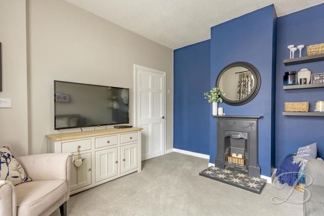 Moving on now to the comfortable living room, with its carpeted floor and feature fireplace. Relaxing here on a night in, in front of the TV, shouldn't be too difficult!