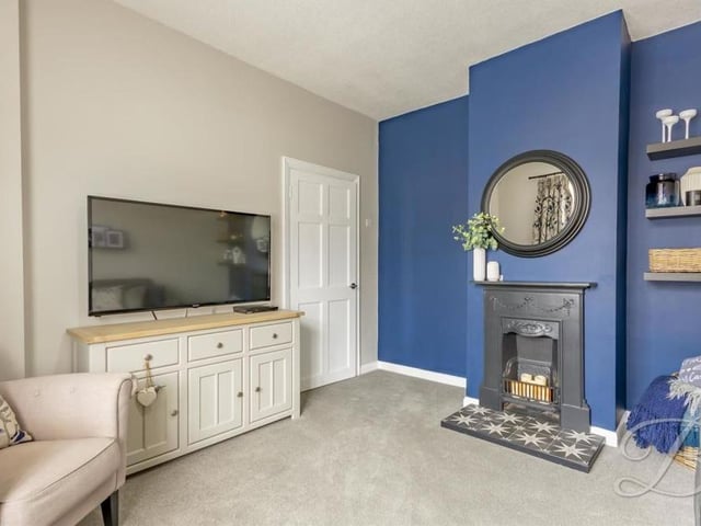 Moving on now to the comfortable living room, with its carpeted floor and feature fireplace. Relaxing here on a night in, in front of the TV, shouldn't be too difficult!