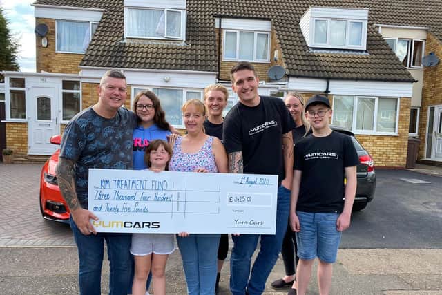 Nick Briton from YumCars hands over the cheque to the Scholefield family.