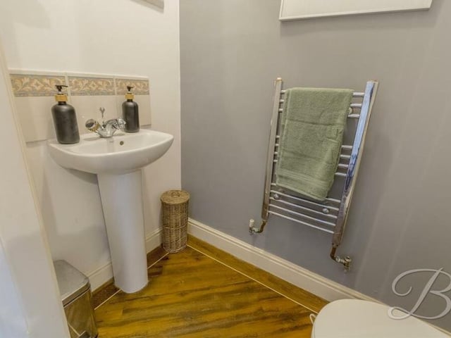 The last of the downstairs spaces to check out is this toilet, with low-flush WC, hand wash basin and towel rail.