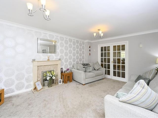 The lounge really does throw out an invitation to sit down and relax in front of the telly. Here, you can also see the double doors to the dining room.