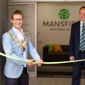 Andy Abrahams, Mansfield mayor, left, officially opens the revamped office watched by Paul Wheeler,  Mansfield Building Society chief executive, and Alison Chmiel, society board chairman.
premises.