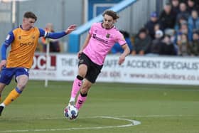 Mansfield Town's Oli Hawkins has joined Gillingham for an undisclosed fee.