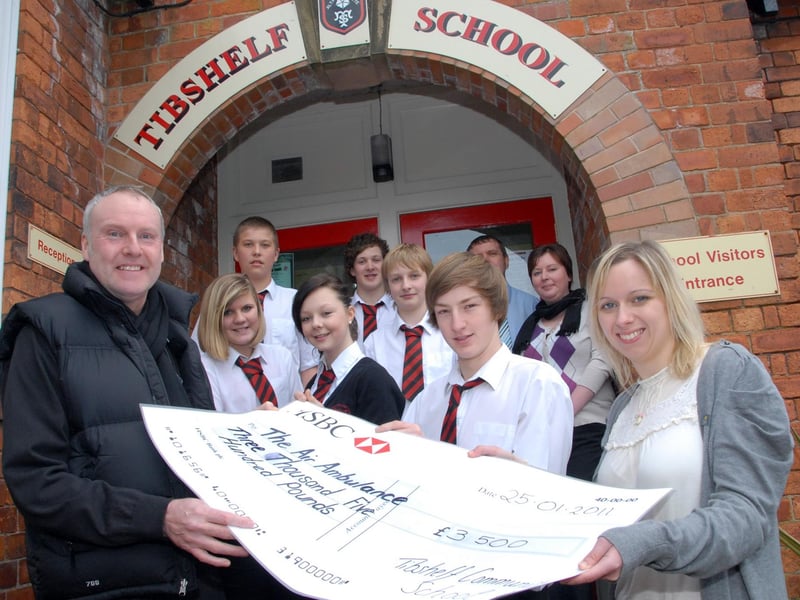 Six pupils, staff and friends from Tibshelf Community School held a sponsored bike ride around Sherwood Pines and raised £3,500 for The Derbyshire, Leicestershire and Rutland Air Ambulance in 2011. Former Teaching Assistant Adrian Pearson, left, and pupils made the presentation to Derbyshire Funding Manager Gemma Hinds, right, at the school on Tuesday.