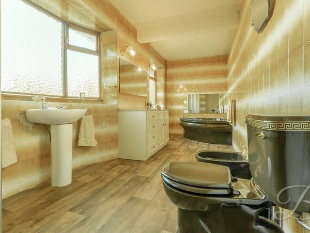 The sizeable family bathroom runs the length of the main bedroom. It features a fitted corner-bath, separate walk-in shower cubicle, low-flush WC, bidet, hand wash basin, vanity unit and full-height tiling.