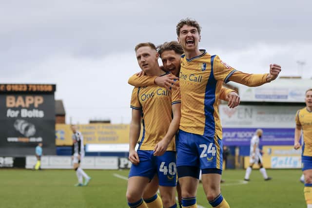Mansfield Town forward Davis Keillor-Dunn celebrates his first half goal with Will Swan (26) and Lewis Brunt (24)  during the Sky Bet League 2 match against Notts County FC at the One Call Stadium, 03 Feb 2024, Photo credit Chris & Jeanette Holloway / The Bigger Picture.media