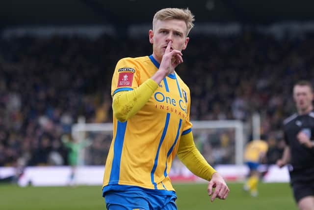 Mansfield Town's Welsh striker #11 Will Evans celebrates after scoring their first goal during the English FA Cup fifth round football match between Mansfield Town and Arsenal at the One Call Stadium, Field Mill in Mansfield, central England on March 7, 2026. (Photo by Jon Super / AFP via Getty Images)