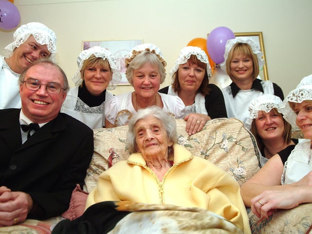 Staff at the Sherwood Grange Care Home, Mansfield Road, Edwinstowe, celebrate the 100th birthday of resident Linda Cooper with a party and dressed up for the event in servants' costumes in the style of 100 years ago .