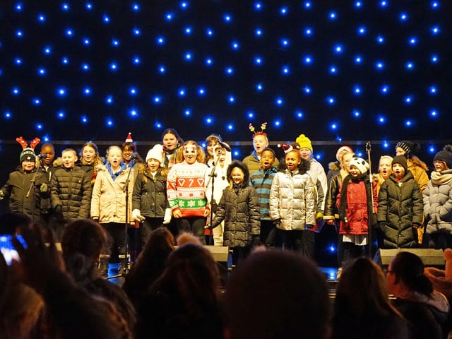 Priestsic School Choir performing on the stage.