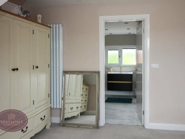 As you can see, the primary bedroom has access to an en suite shower room, which we will take a closer look at next.