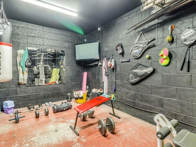 The integral double garage at the property has been converted into a store and utility area with a connecting door that leads through to this fabulous gym. It features two LED fluorescent ceiling-light points, power points, work surfaces and fitted shelving.