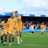 Nathan Moriah-Welsh celebrates his 1st half goal with Jon Russell and Michael Smith during the Sky Bet League 1 match against Luton Town FC at the One Call Stadium, 30 Aug 2026, Photo credit Chris & Jeanette Holloway / The Bigger Picture.media