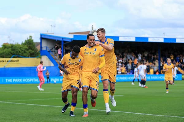 Nathan Moriah-Welsh celebrates his 1st half goal with Jon Russell and Michael Smith during the Sky Bet League 1 match against Luton Town FC at the One Call Stadium, 30 Aug 2026, Photo credit Chris & Jeanette Holloway / The Bigger Picture.media