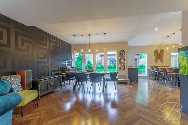 The dining area at the £495,000 property is a delightful space with a striking wall design, shiny parquet flooring and French doors that lead out to the rear garden.
