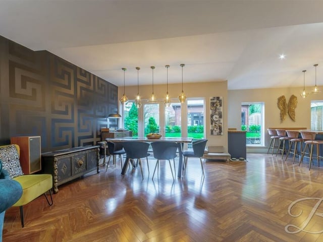 The dining area at the £495,000 property is a delightful space with a striking wall design, shiny parquet flooring and French doors that lead out to the rear garden.