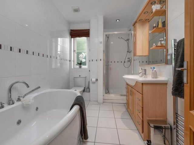 The en suite bathroom to the master bedroom can only be described as excellent. Marvel at its Jacuzzi bathtub, separate, tiled shower enclosure and vanity unit with inset wash hand basin that has a storage cupboard and drawers beneath and a fitted mirror with inset spotlights above.