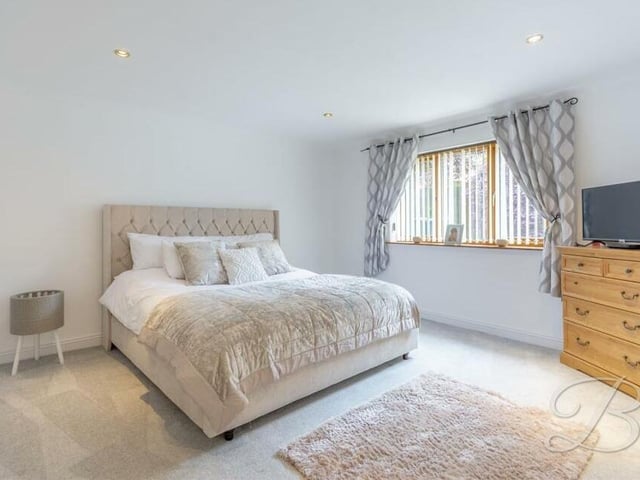 Three of the five bedrooms are on the ground floor of the Yew Tree Drive property, including this one, which faces the side of the bungalow.