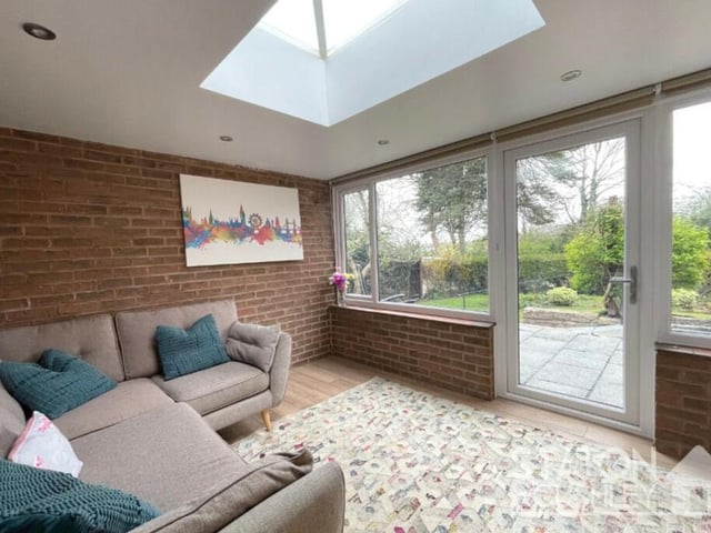 Another attractive living space at the £525,000 property is this comfortable conservatory, which overlooks the back garden. A door opens out to that garden, while further bi-fold doors lead back to the lounge.