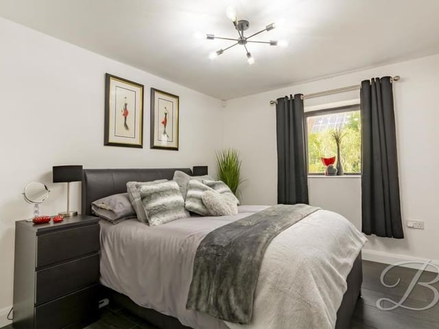 Bedroom number two at the Clipstone Road West property is also on the ground floor and also benefits from underfloor heating. It has access to en suite facilities, while the window faces the front of the house.