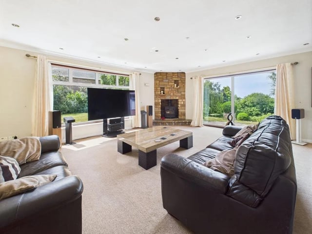 The property features a spacious lounge with dual aspect windows and a fireplace