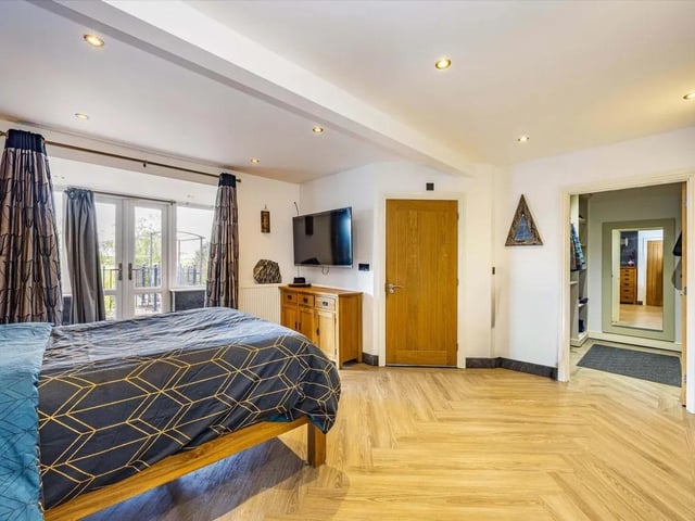 The lower ground floor reveals two further bedrooms, including a stunning master suite that enjoys a wonderful sense of privacy and a luxury en suite and walk-in-wardrobe