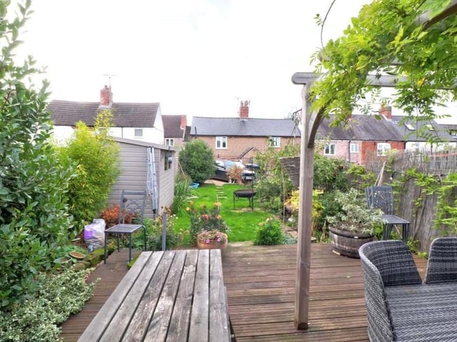 Looking down the lengthy back garden, you can see that it features two storage sheds that have light and power. There is also an outbuilding containing a WC.