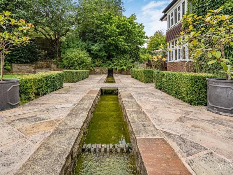As well as the fountain at the front of the property, there is this tranquil water feature that runs through the back garden.