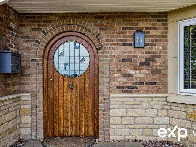 The front door, adorned with decorative stained glass, introduces a flourish of colour as it opens into the uniquely configured reception hall.